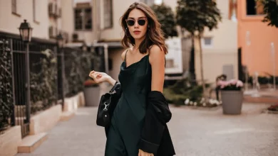 a person wearing sunglasses and a black dress